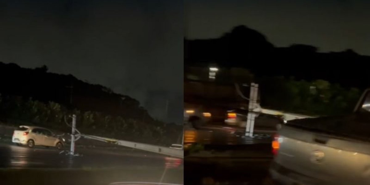 Poste cai e fica atravessado na Avenida Paralela após colisão de carro