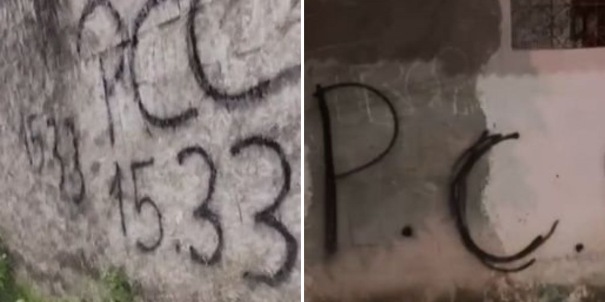 Muros pichados com as iniciais de uma facção criminosa